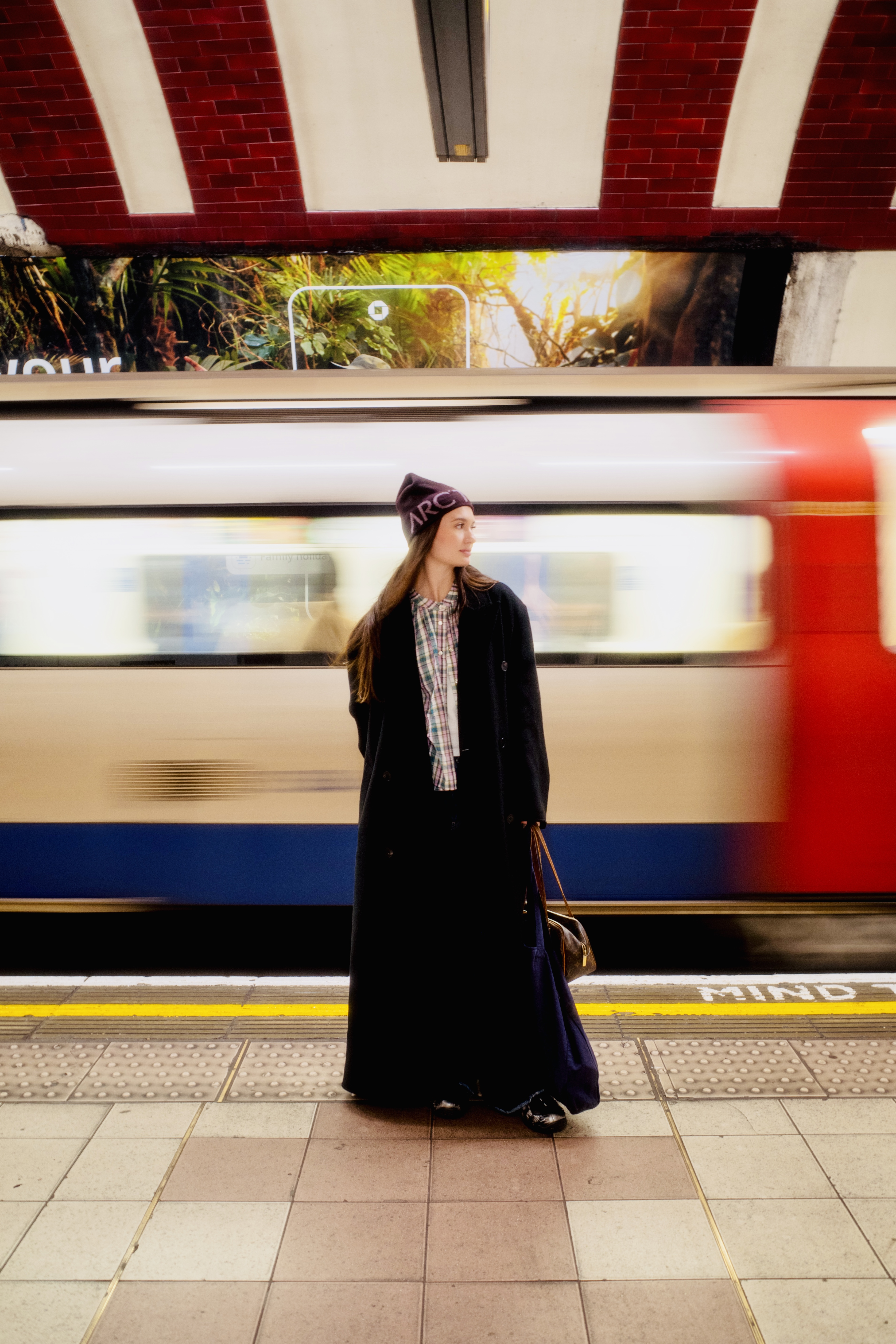 Color portrait on a tube platform, train motion blur