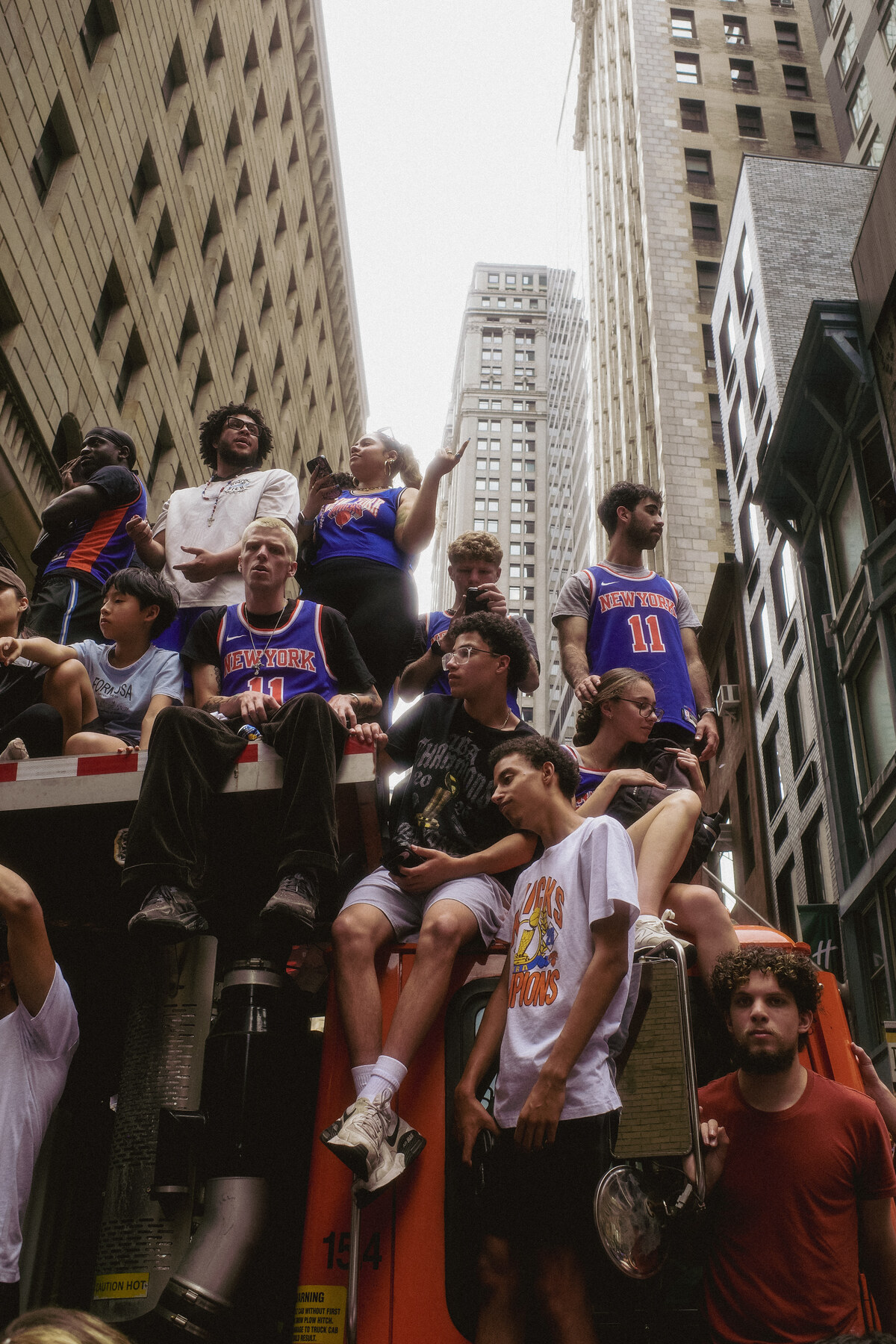 Knicks fans packed on a truck cab during the parade, close-up