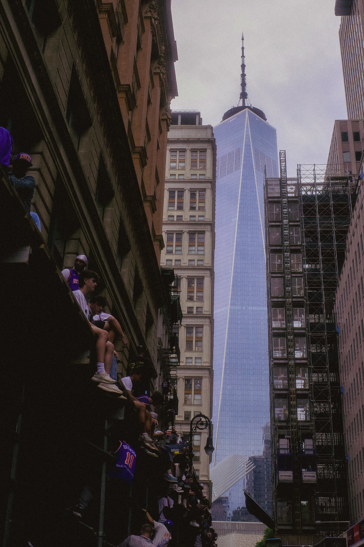 Knicks fans climbing fire escape, One World Trade Center in background